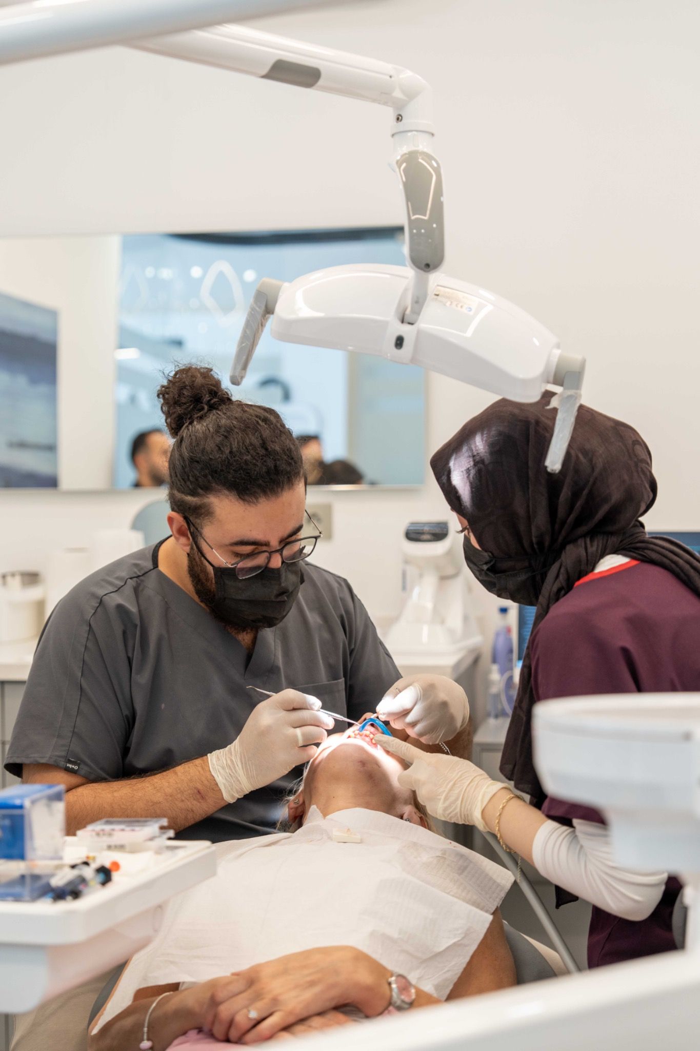A dentist and a team member caring for a patient.